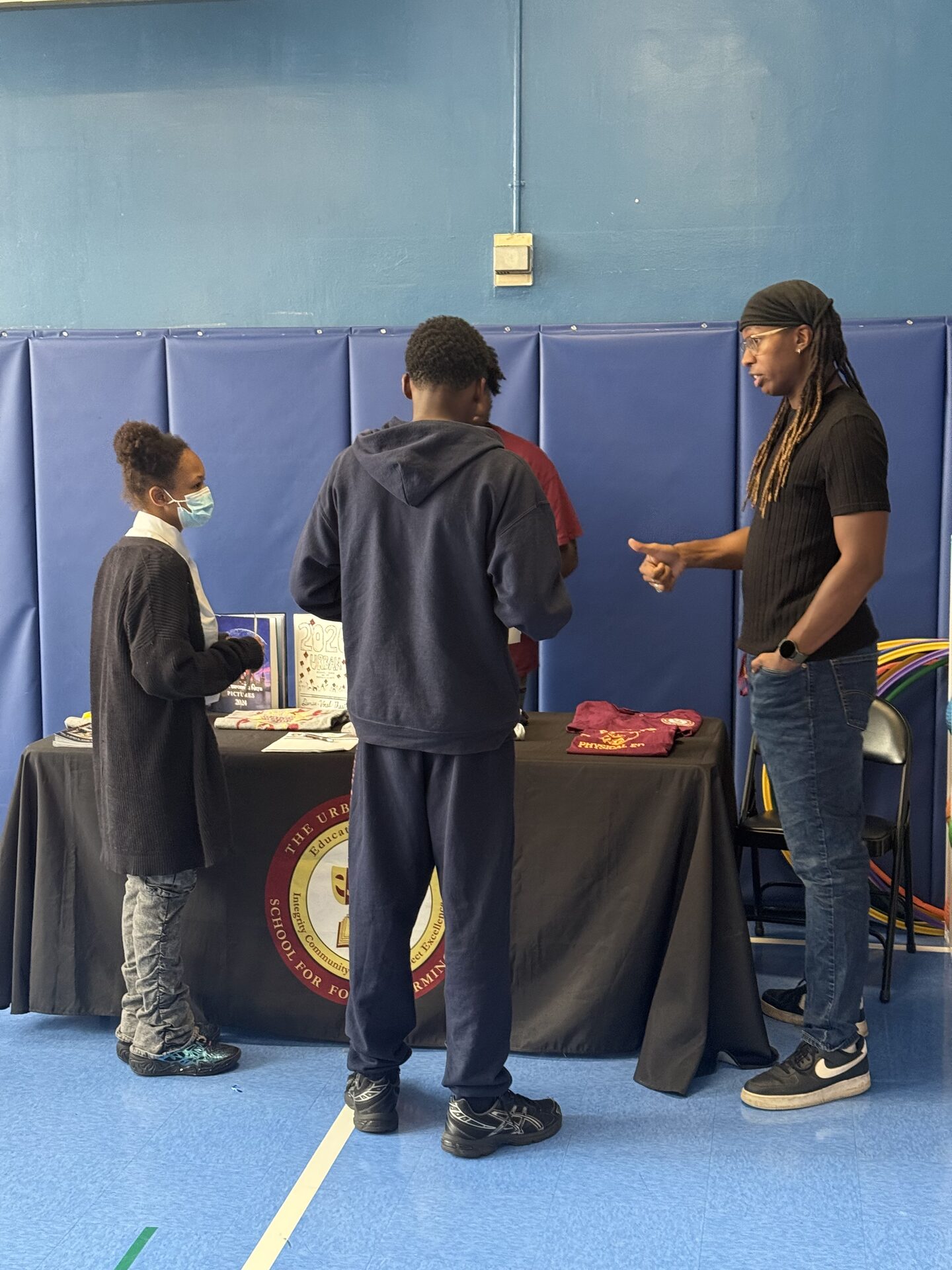 The Lexington Academy — Students learning about a high school at an information table